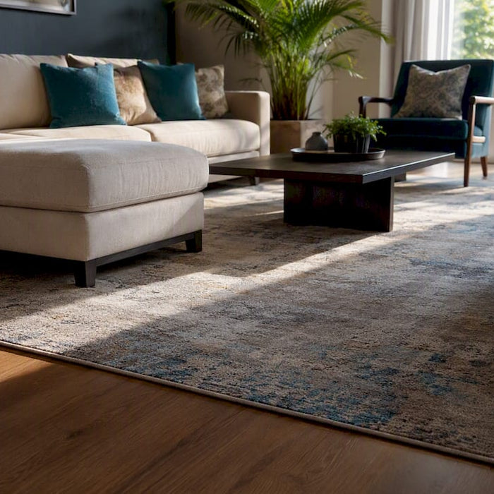 Living room with sofa and chairs anchored by large rug