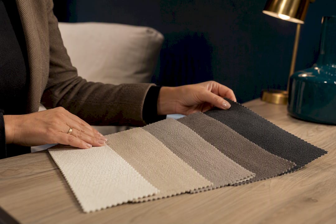 Neutral upholstery swatches in showroom consultation