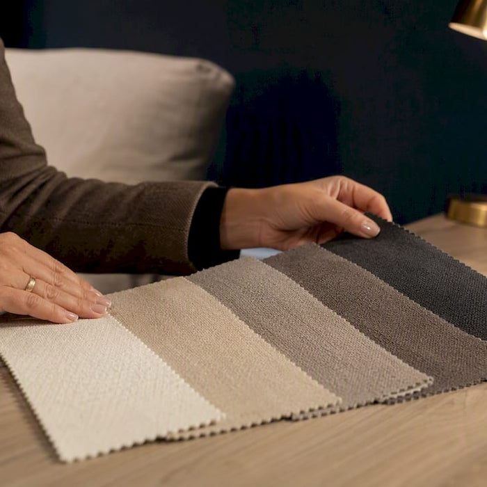 Neutral upholstery swatches in showroom consultation