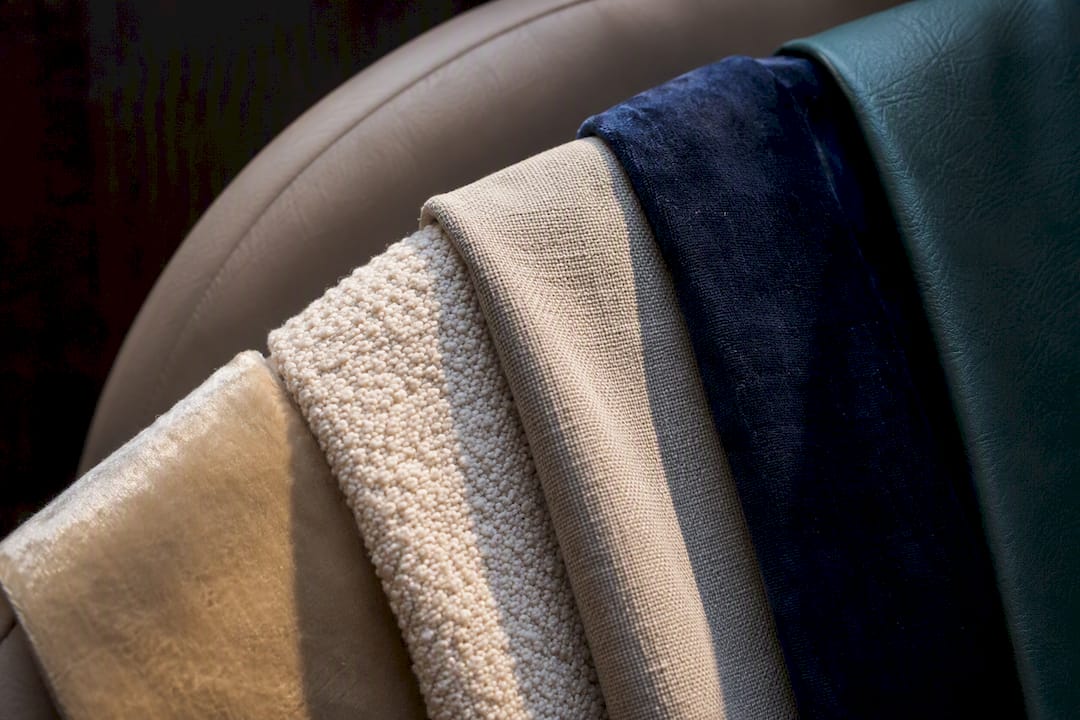 Upholstery fabric swatches on padded headboard edge