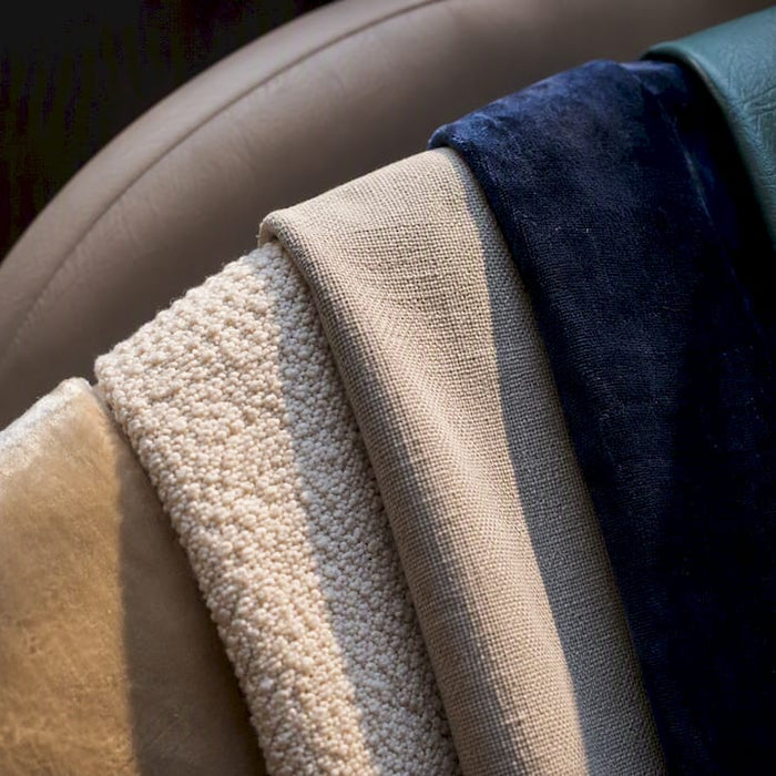Upholstery fabric swatches on padded headboard edge