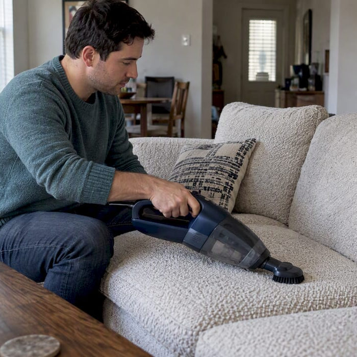 Homeowner vacuuming a bouclé sofa